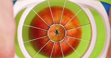 Close View Of Apple Core Extraction Process, Bright Kitchen Scene With Freshly Cut Apple And Juice