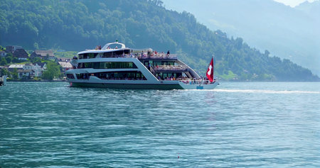 Quiet Lake Voyage, Tranquil Passenger Vessel Sailing Across Vibrant Alpine Lake During Dawn