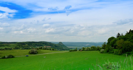Green hills and blue sky show natures beauty in a rural area during a sunny day in the countryside