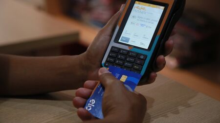 SALVADOR, BAHIA / BRAZIL - November 22, 2019: person uses credit card machine in shoppng shop in the city of Salvador (BA) (Joa Souza).のeditorial素材