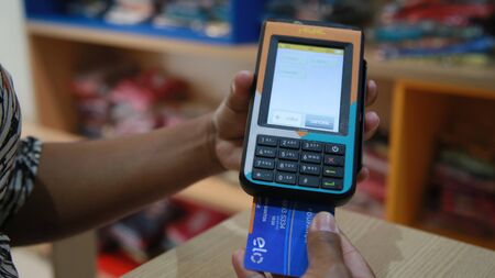 SALVADOR, BAHIA / BRAZIL - November 22, 2019: person uses credit card machine in shoppng shop in the city of Salvador (BA) (Joa Souza).のeditorial素材