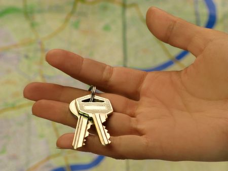 Female hand holding key in front of a Shanghai mapのeditorial素材