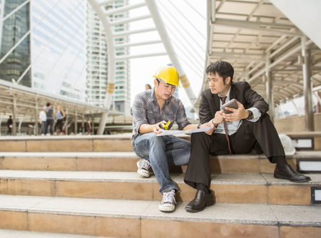 Asia leader and worker are work together in the cityの写真素材