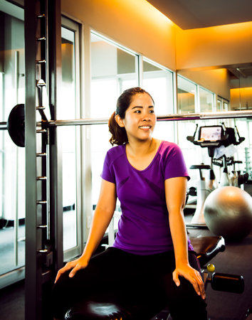 Asia woman enjoy sport in sport club with hi exposure and concentrate light in dark toneの写真素材