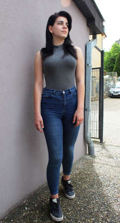 Young black haired girl posing outside