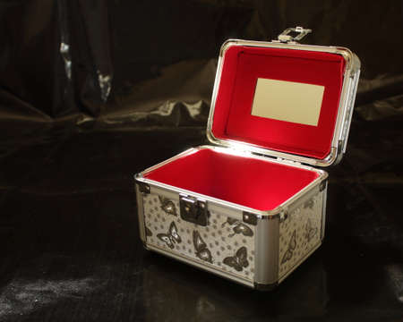 Open gray red makeup case on a black backgroundの写真素材