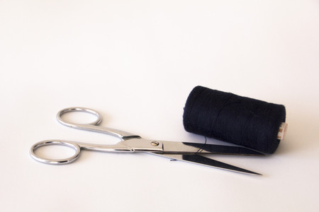 scissors with a ball of blue threadの写真素材