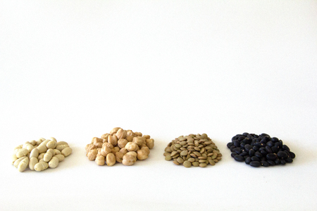 piles of White beans, peas, lentils and black beans with white blackgroundの写真素材