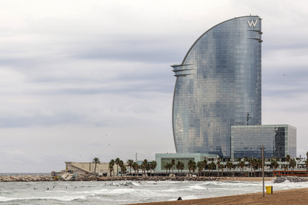 BARCELONA,SPAIN-SEPTEMBER 29,2015: Barceloneta beach and Modern architecture, Hotel W or Hotel Vela, by architect Ricard Bofill.のeditorial素材