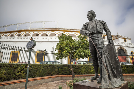 SEVILLE,SPAIN-NOVEMBER 16,2011: Bullring, Plaza de Toros La Maestranza and statue tribute to Curro Romero, torero.Sevilla,Andalicia,Spain.のeditorial素材