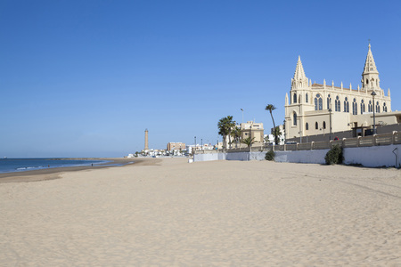 CHIPIONA,SPAIN-NOVEMBER 15,2016: Beach and Sanctuary of Nuestra Senora de la Regla, maritime promenade of Chipiona, Andalucia.のeditorial素材