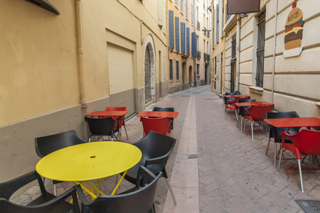 PERPIGNAN,FRANCE-JULY 23,2014: Bar tables in a narrow street of Perpignan,Languedoc-Roussillon,France.のeditorial素材