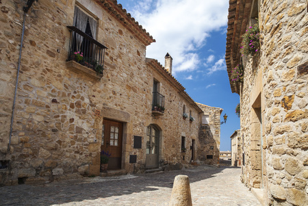 PALS,SPAIN-MAY 23,2012: Street view in the medieval and ancient village of Pals, touristic and...