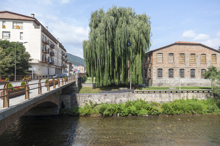 CAMPDEVANOL,SPAIN-JULY 13,2015: Village view, bridge and Freser river in catalan village of Campdevanol, province Girona, Catalonia.のeditorial素材