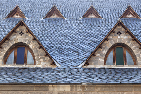RIBES DE FRESER,SPAIN-JULY 13,2015: Architecture element, detail windows church, typical mountain construction, slate roof, Ribes de Freser, province Girona, Catalonia.のeditorial素材