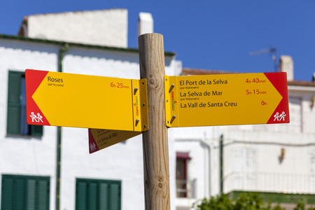 CADAQUES,SPAIN-MAY 21,2015: Sign distance destination, treeking route,Cap de Creus area in mediterranean village, Cadaques,Costa Brava,province Girona, Catalonia.のeditorial素材