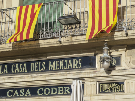 REUS,SPAIN-NOVEMBER 29,2012: Restaurant facade La Casa dels Menjars-Casa Corder, with catalan flag balcony, founded in 1790 sign, Reus, province Tarragona,Catalonia.のeditorial素材