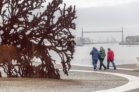 SESTAO,SPAIN-JANUARY 12,2017:Promenade next to Nervion river, at background Vizcaya bridge.Sestao,Basque Country,Spain.のeditorial素材