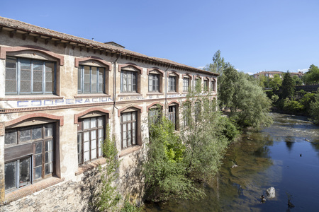 OLOT,SPAIN-MAY 8,2017:Ancient factory building over river.Olot,Catalonia,Spain.のeditorial素材