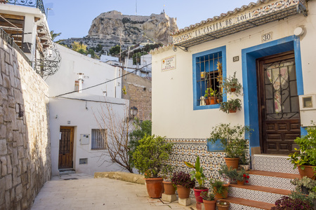 ALICANTE, SPAIN- JANUARY 18, 2018: Colored picturesque houses, street.Typical neighborhood historic center, casco antiguo,barrio santa cruz.Alicante, Spain.のeditorial素材