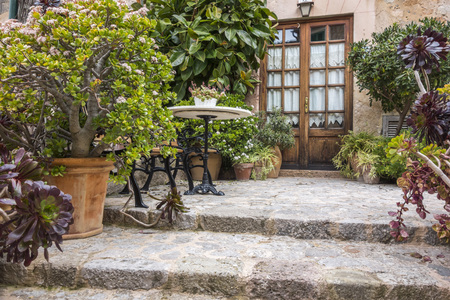 VALLDEMOSSA,SPAIN-MARCH 6,2018: Door entrance, patio, traditional house in village of Vallmodessa, Majorca Island, Spain.のeditorial素材