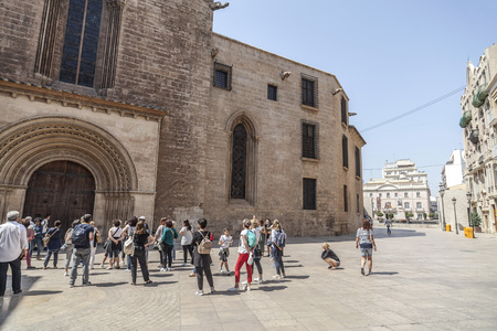 VALENCIA,SPAIN-MAY 9,2018: Group tourists front cathedral door, Valencia.