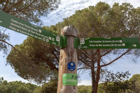 LLORET DE MAR,SPAIN-APRIL 1,2019: Sign distance route between Lloret de Mar and Tossa de Mar, Costa Brava.のeditorial素材