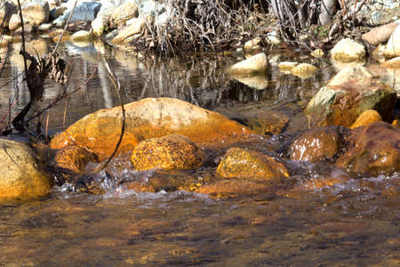 Water flowing over Orange Rocks