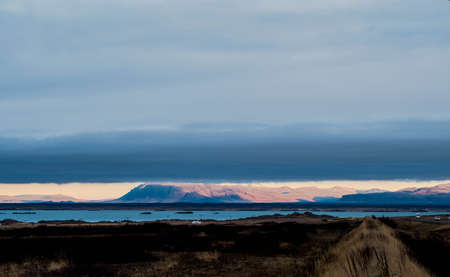 A gigantic cloud covers almost the entire sky except the horizon in Icelandの写真素材