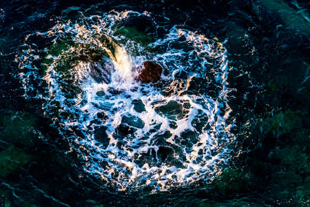The waves of the sea in Benidorm, Spain, breaking against the rocks form a heartの写真素材