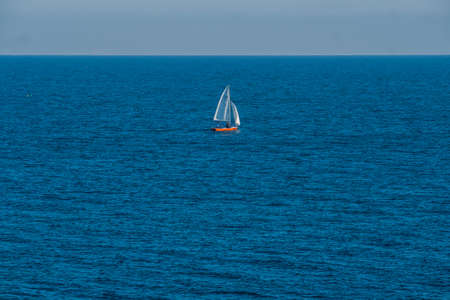 Sailing boats cross the waters of the island of Tabarca, in the Spanish Mediterranean, in front of Santa Pola, Alicanteの写真素材