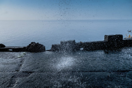 A waterfall falls in the middle of the road in Ponta do Sol, Madeiraの写真素材