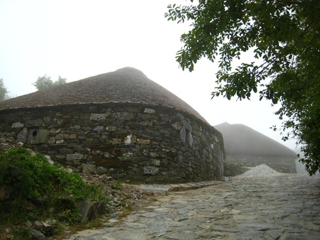 Ancient huts in a small village, with stone path の写真素材