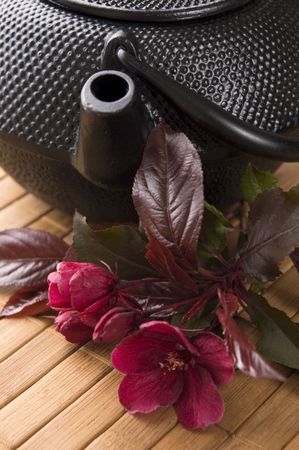 teapot with a fresh flowers on the bamboo trayの写真素材