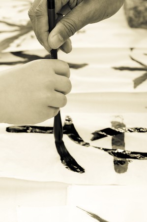Teacher Helping Student drawing hieroglyph の写真素材