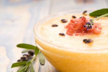 fresh melon soup with parma ham and lavender flowerの写真素材
