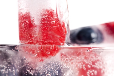 Raspberry and blackberry frozen in ice sticksの写真素材