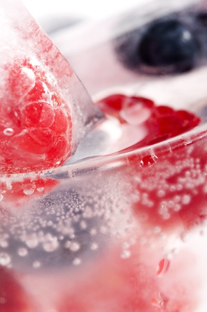 Raspberry and blackberry frozen in ice sticksの写真素材
