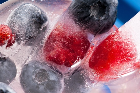 Raspberry and blackberry frozen in ice sticksの写真素材