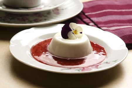 Vanilla panna cotta with berry sauce and spring flowerの写真素材