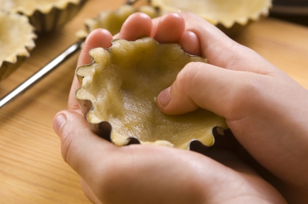 Detail of child hands making cookiesの写真素材