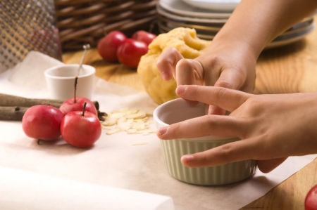Detail of child hands making apple pieの写真素材