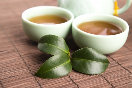 A cup of green tea with freh leavesの写真素材