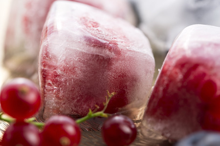 Fresh berry fruits frozen in ice cubesの写真素材
