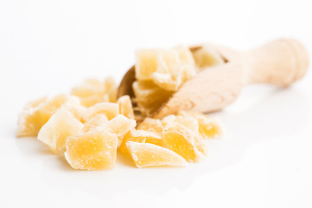 Caramelized ginger candy pieces isolated on white backgroundの写真素材