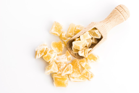 Caramelized ginger candy pieces isolated on white backgroundの写真素材