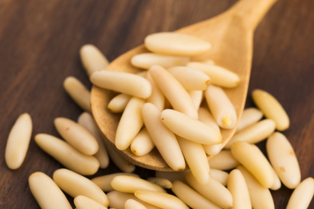 Dry Organic Pine Nuts on Wooden Backgroundの写真素材