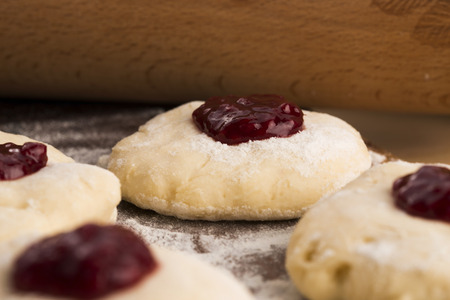 Dough with marmelade on wooden boardの写真素材