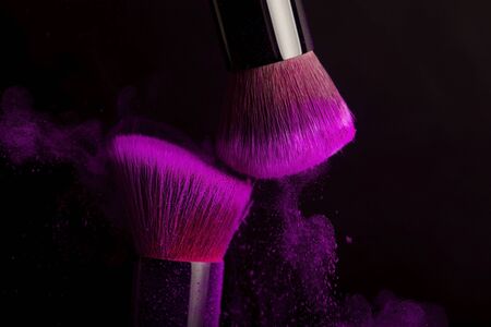 Cosmetics brush and colorful makeup powder