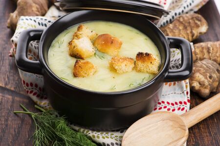 Creamy Jerusalem artichoke soup on wooden backgroundの写真素材